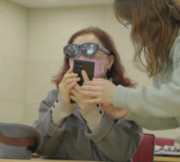 A person with low vision is experiencing the Relumino glasses provided through a pilot distribution program at Gyeonggi Welfare Foundation for the Visually Handicapped, South Korea